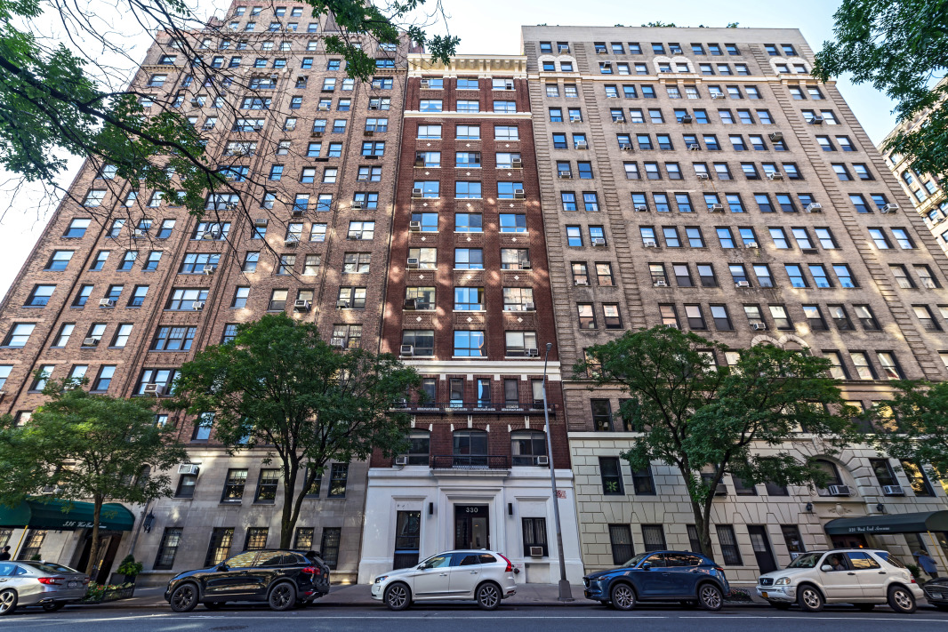 330 West End Avenue, Unit 2B Manhattan, NY 10023 - Photo 13 of 14 a front view of a building with lot of cars and trees