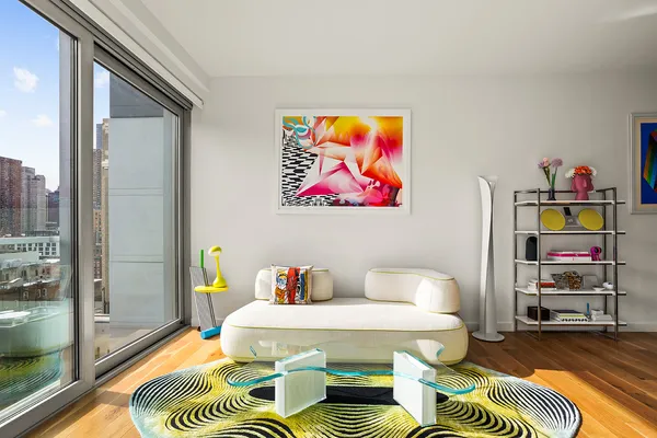 a living room with furniture and a floor to ceiling window