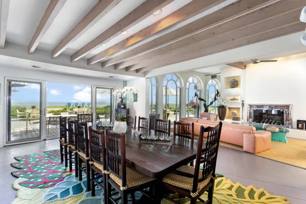 a view of a dining room with furniture large windows and wooden floor