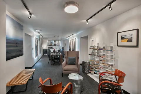 a living room with furniture and a view of kitchen
