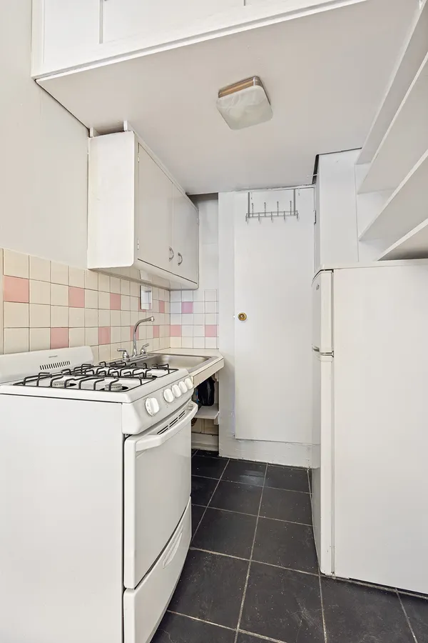 a kitchen with cabinets and white stainless steel appliances