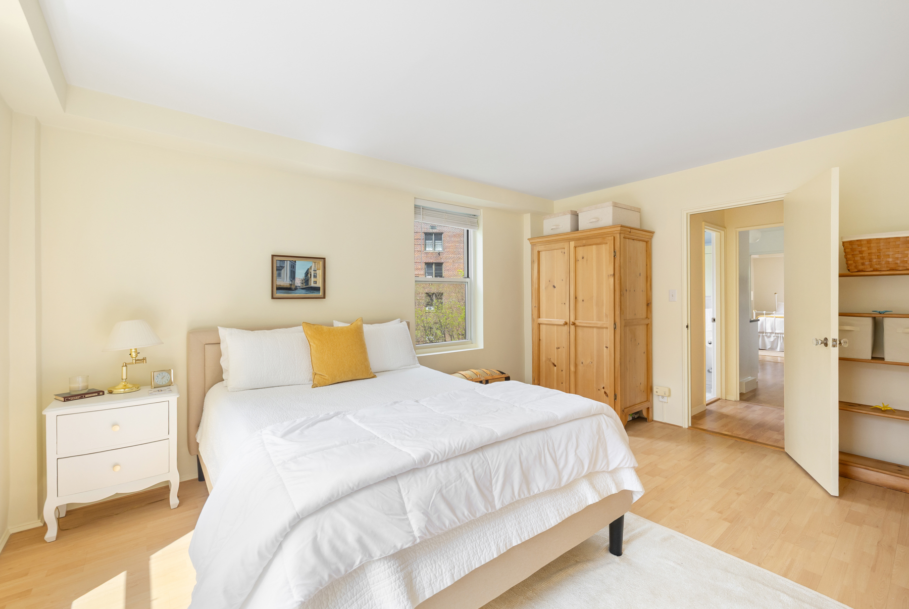 35-11 85th Street, Unit 5H Queens, NY 11372 - Photo 2 of 11 a bedroom with a large bed and a couch