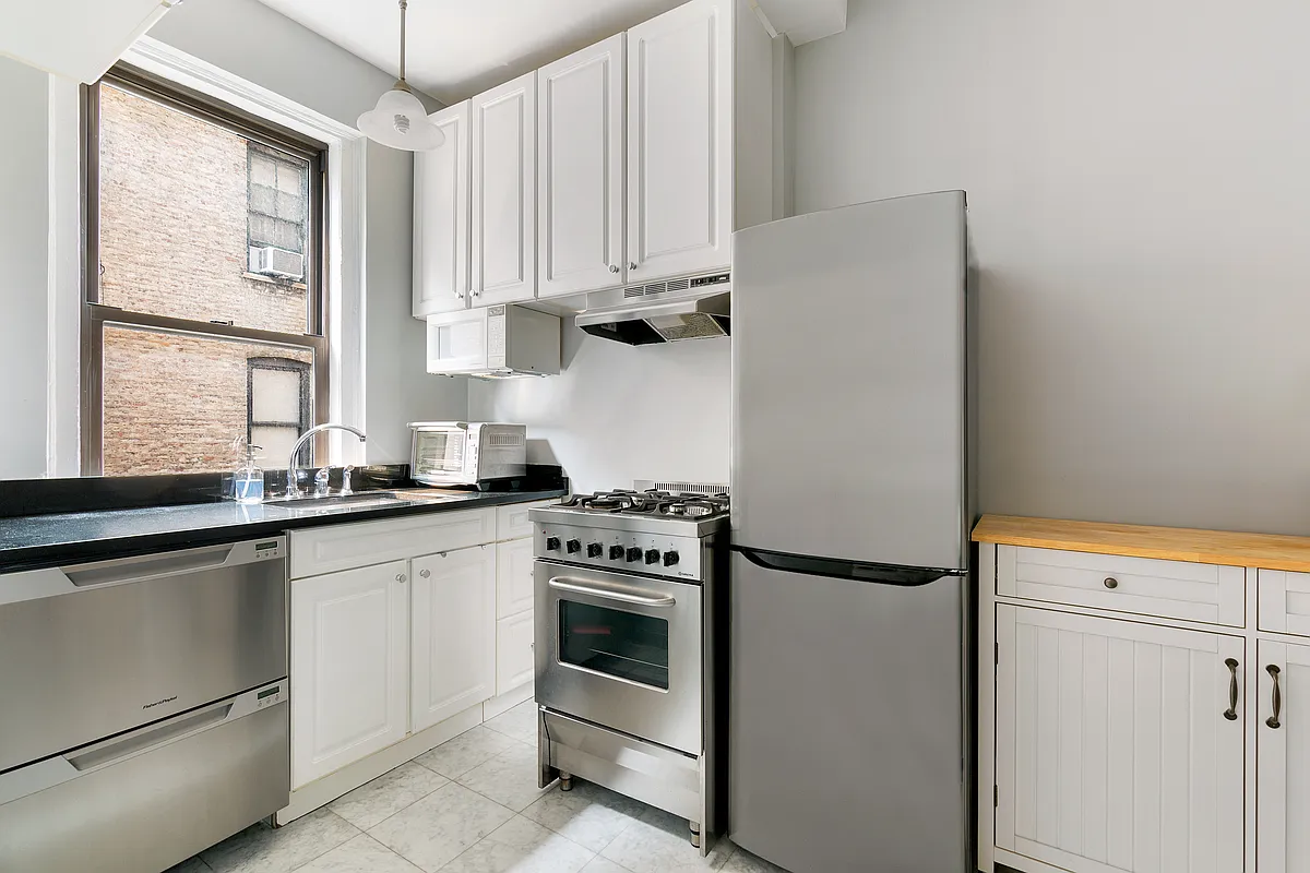 675 West End Avenue, Unit 4C Manhattan, NY 10025 - Photo 5 of 10 a kitchen with appliances cabinets and a sink