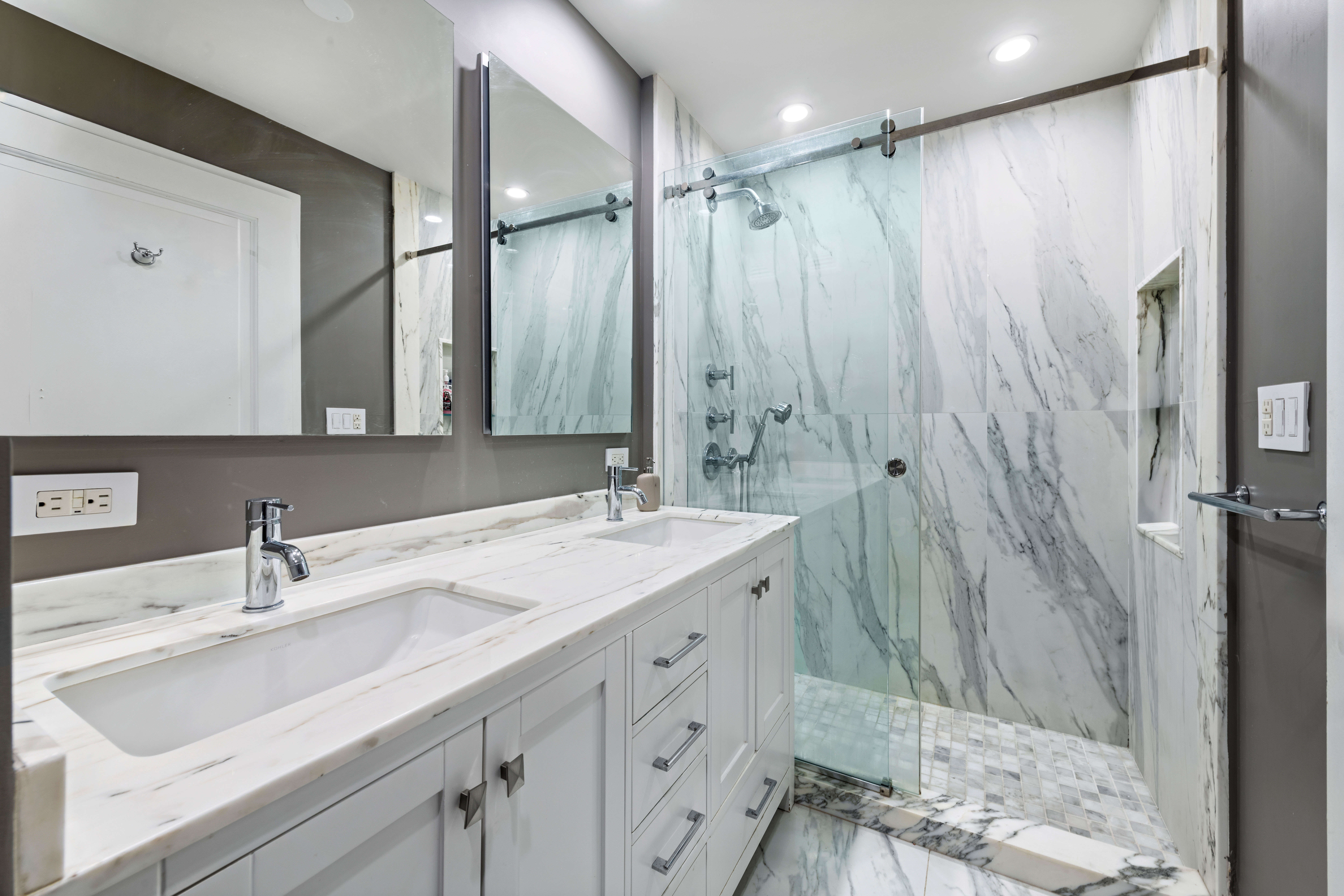 404 East 76th Street, Unit 8A Manhattan, NY 10021 - Photo 10 of 17 a bathroom with a sink double vanity and a mirror