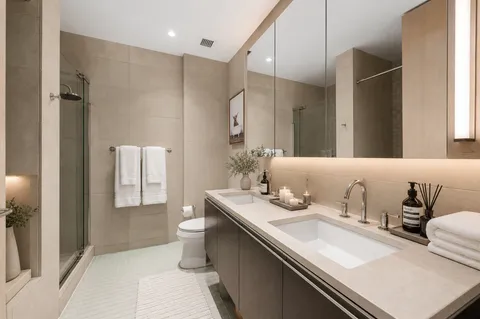 a bathroom with double sink and a mirror