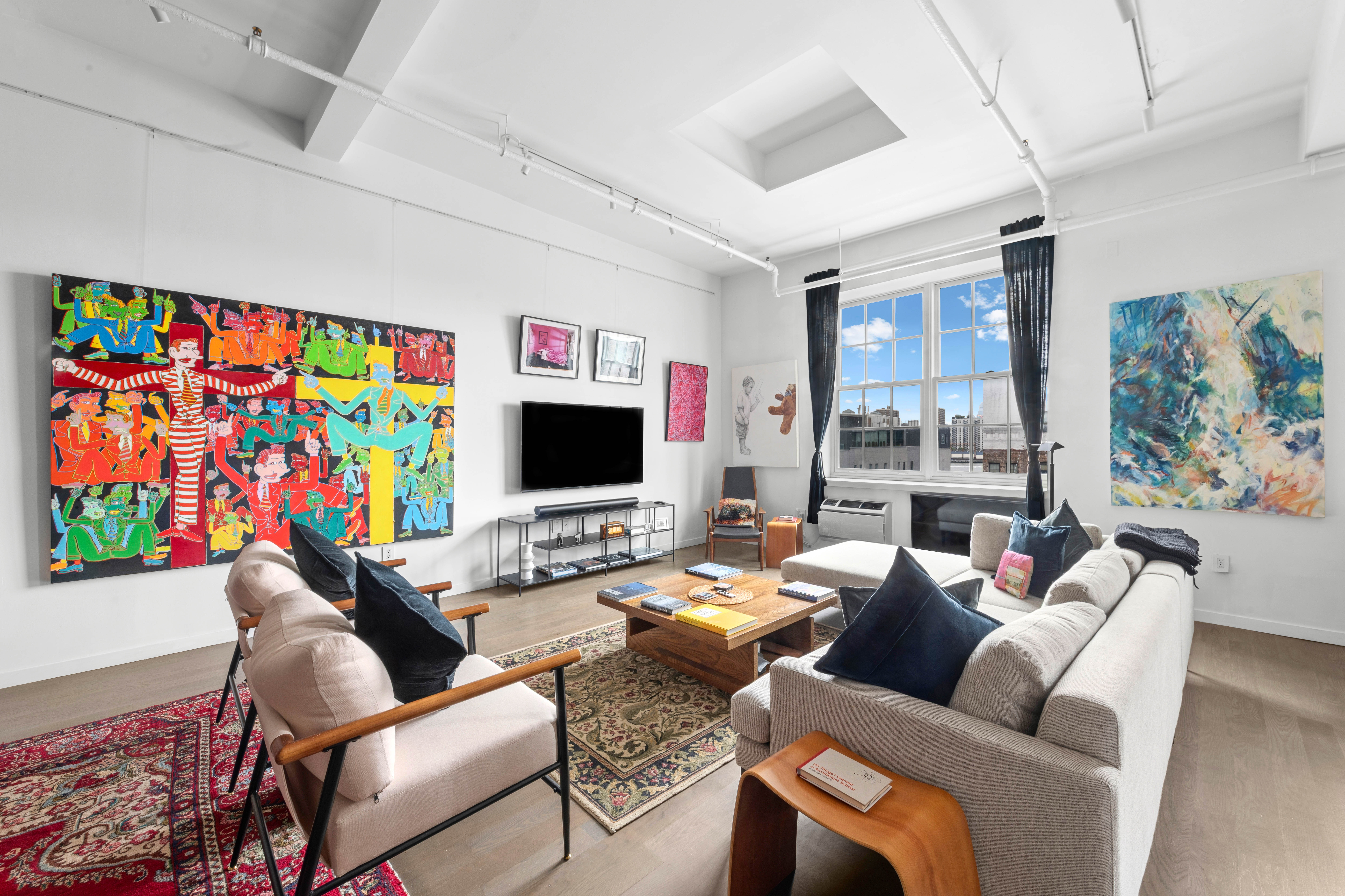 a work room with furniture and a flat screen tv