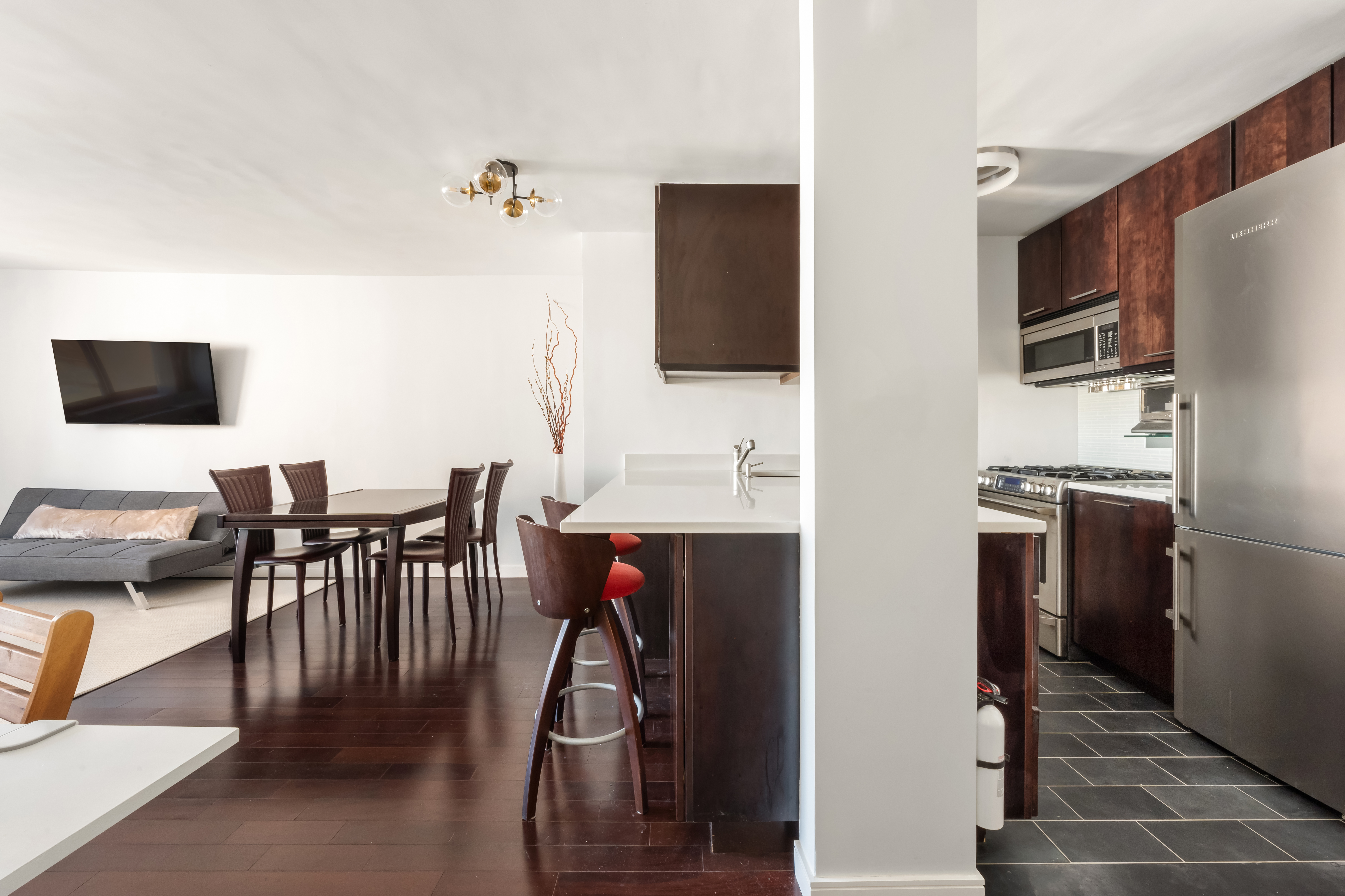 376 Broadway, Unit 14E Manhattan, NY 10013 - Photo 5 of 11 a view of a dining room with furniture and wooden floor