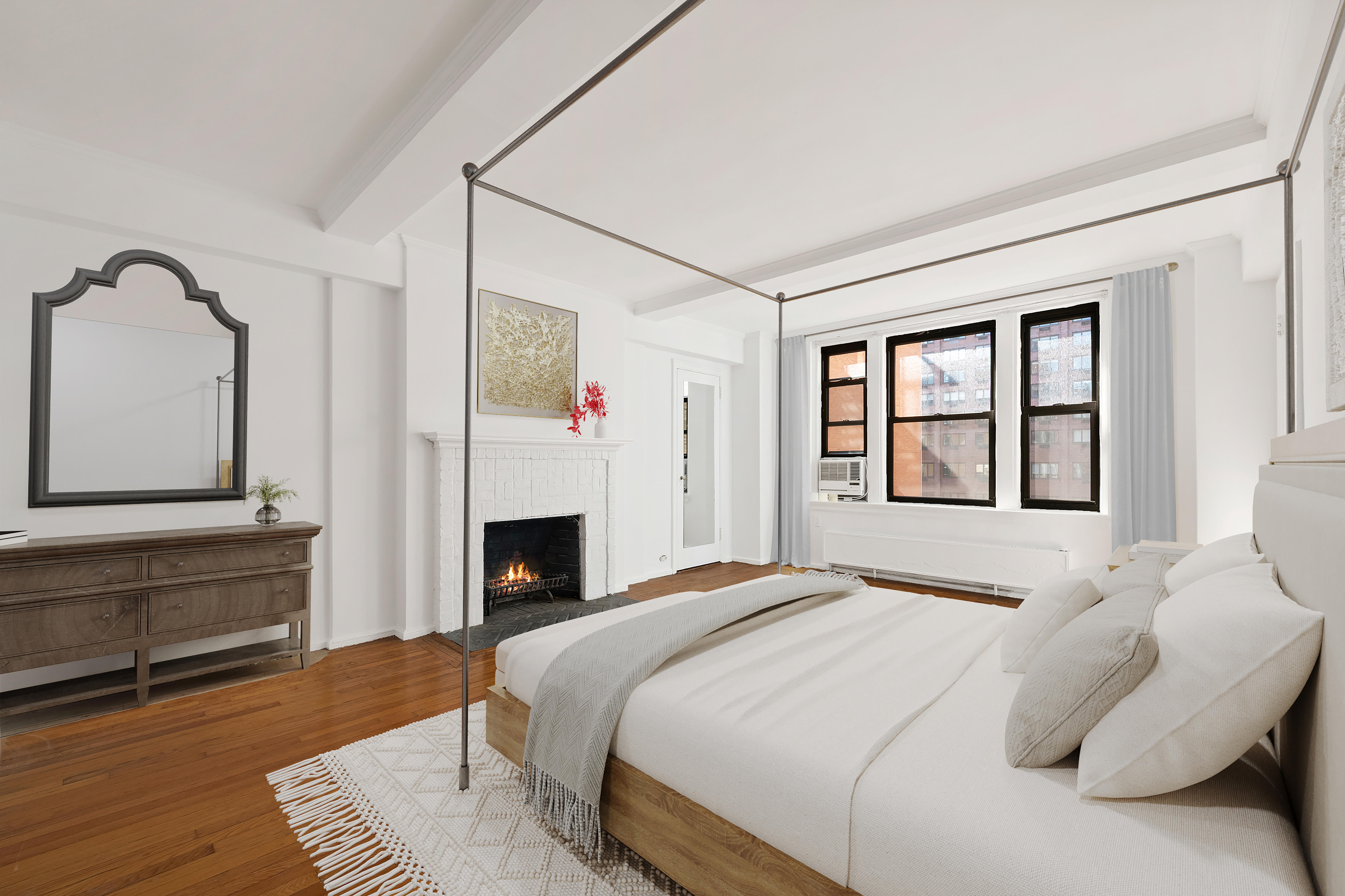 210 East 73rd Street, Unit 9EF Manhattan, NY 10021 - Photo 3 of 16 a bedroom with a bed and a fireplace