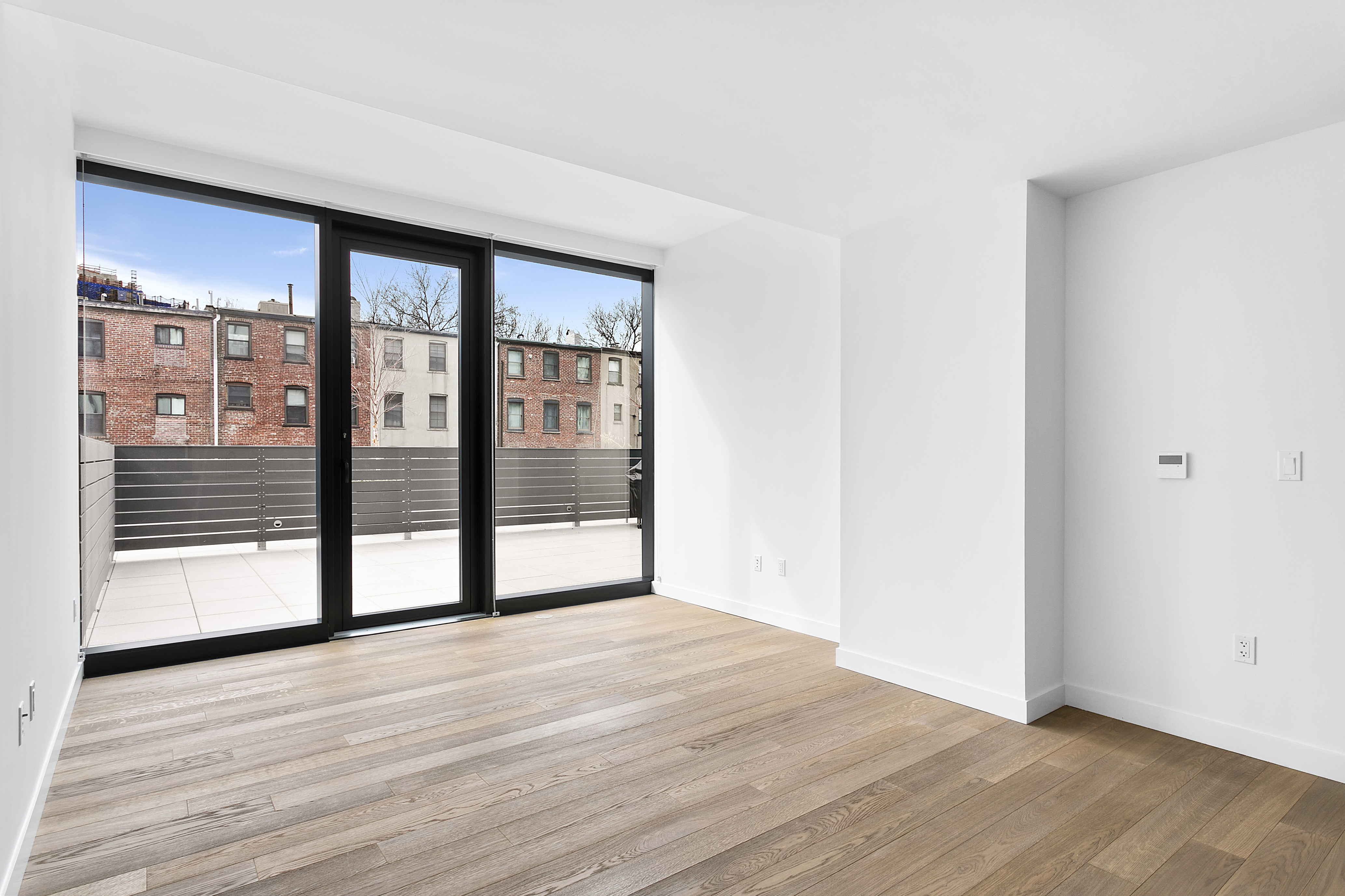 21-30 44th Drive, Unit 2D Queens, NY 11101 - Photo 3 of 6 a view of empty room with wooden floor and fan
