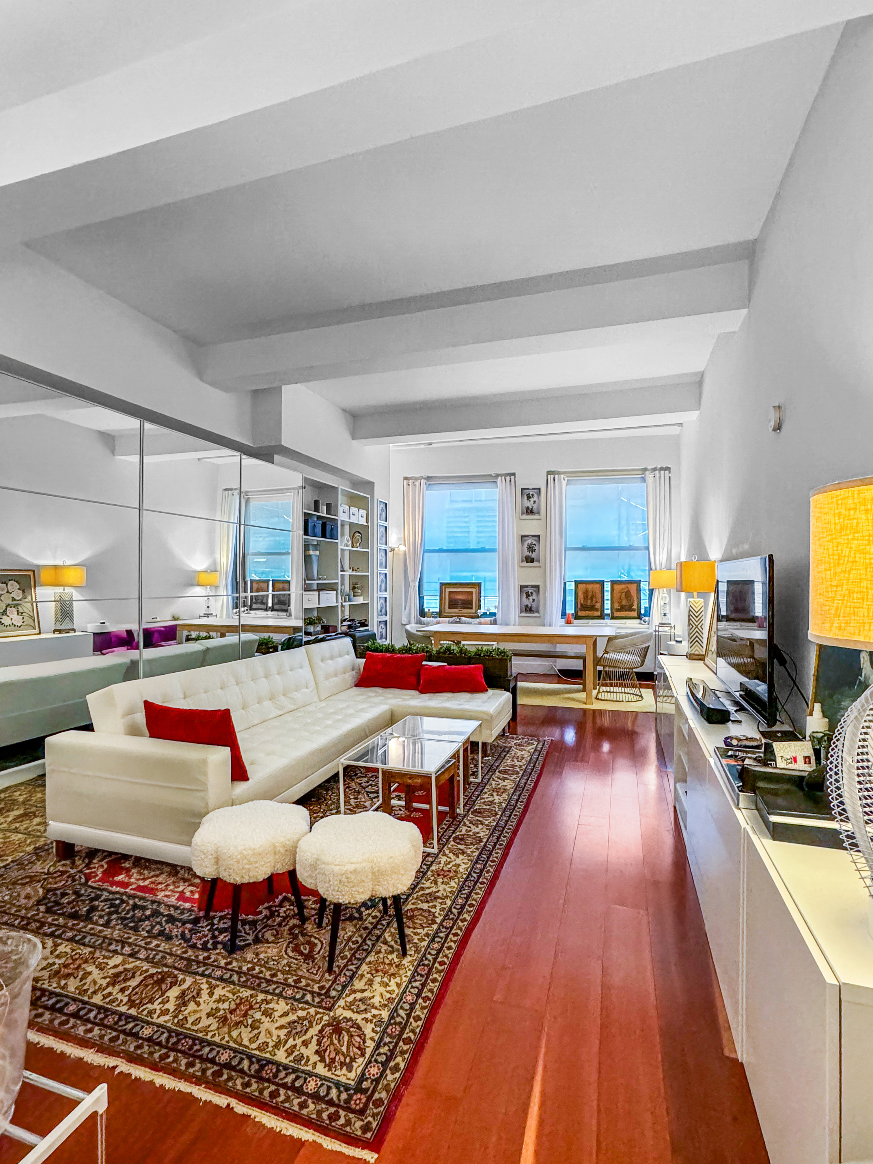 a living room with lots of furniture and kitchen view