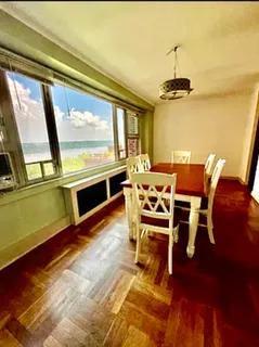 a dining room with furniture a chandelier and wooden floor