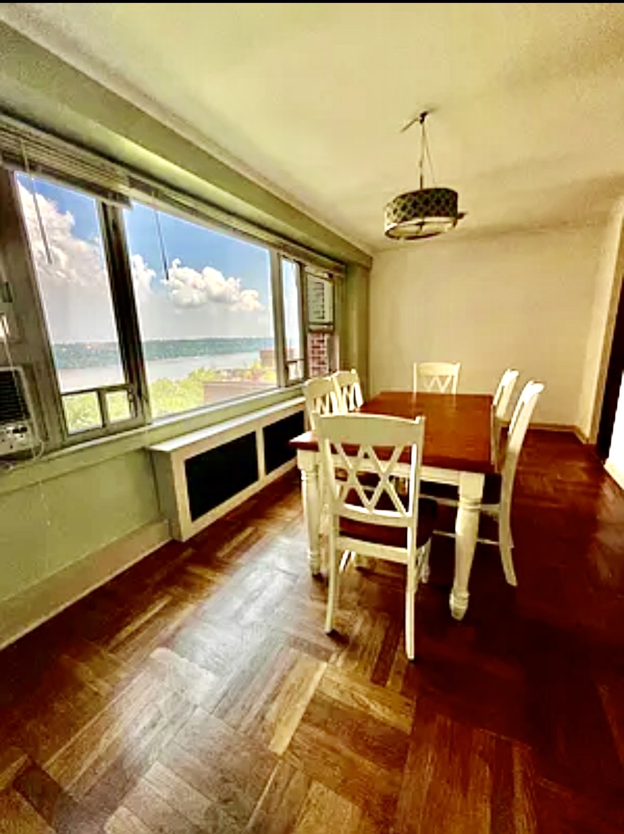 900 West 190th Street, Unit 9B Manhattan, NY 10040 - Photo 6 of 16 a dining room with furniture a chandelier and wooden floor