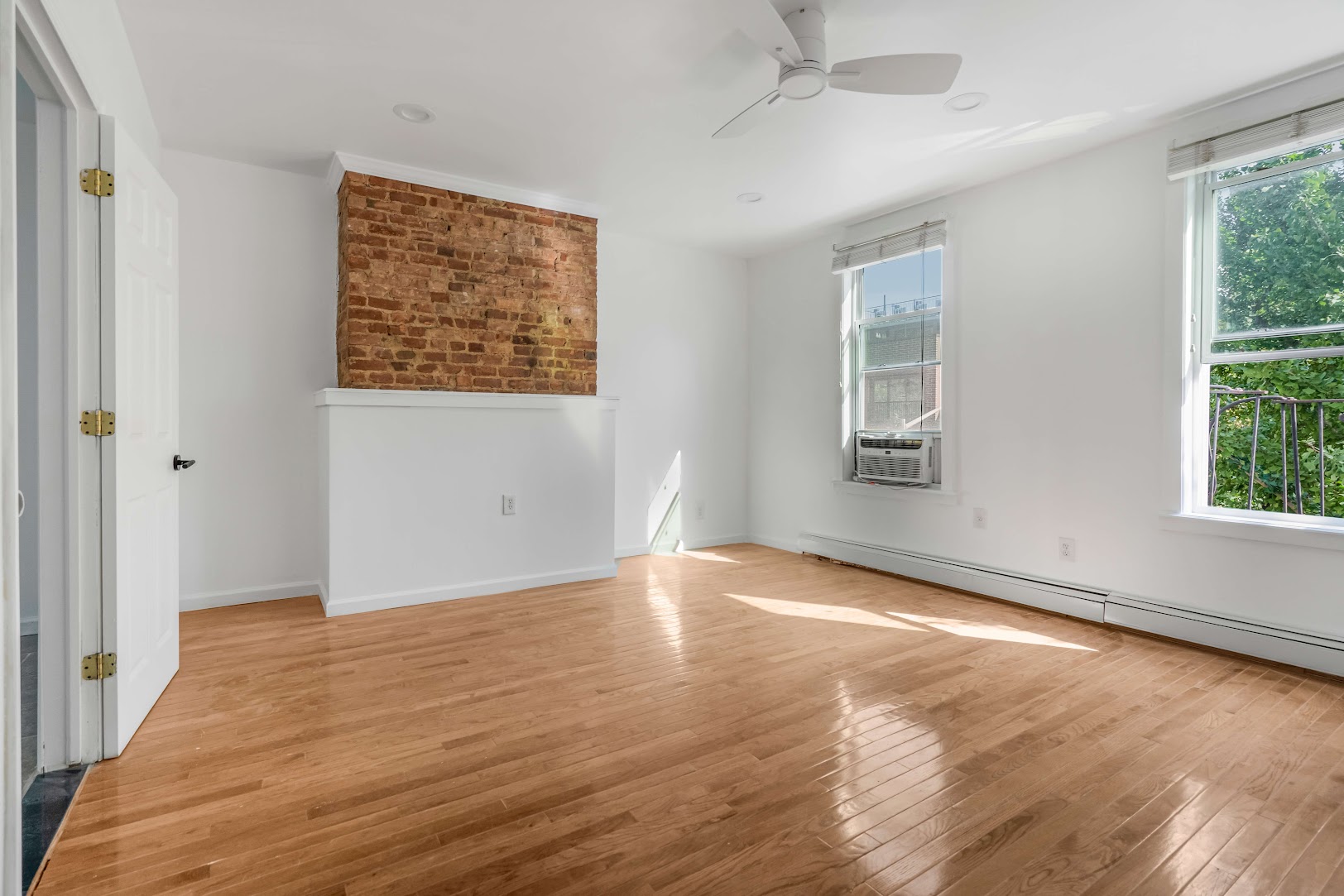185 A Powers Street, Unit 3 Brooklyn, NY 11211 - Photo 2 of 12 an empty room with wooden floor and windows