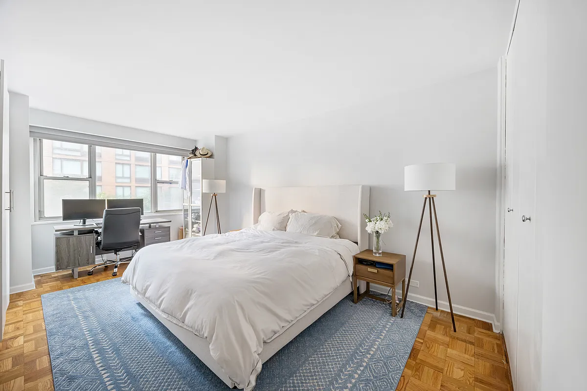 300 East 40th Street, Unit 3J Manhattan, NY 10016 - Photo 5 of 8 a bedroom with a bed and wooden floor