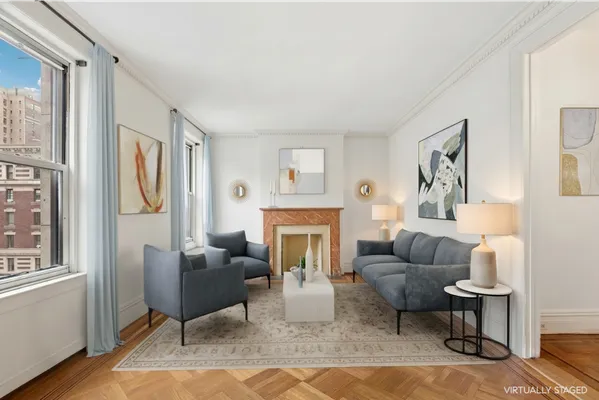 a living room with furniture fireplace and a window