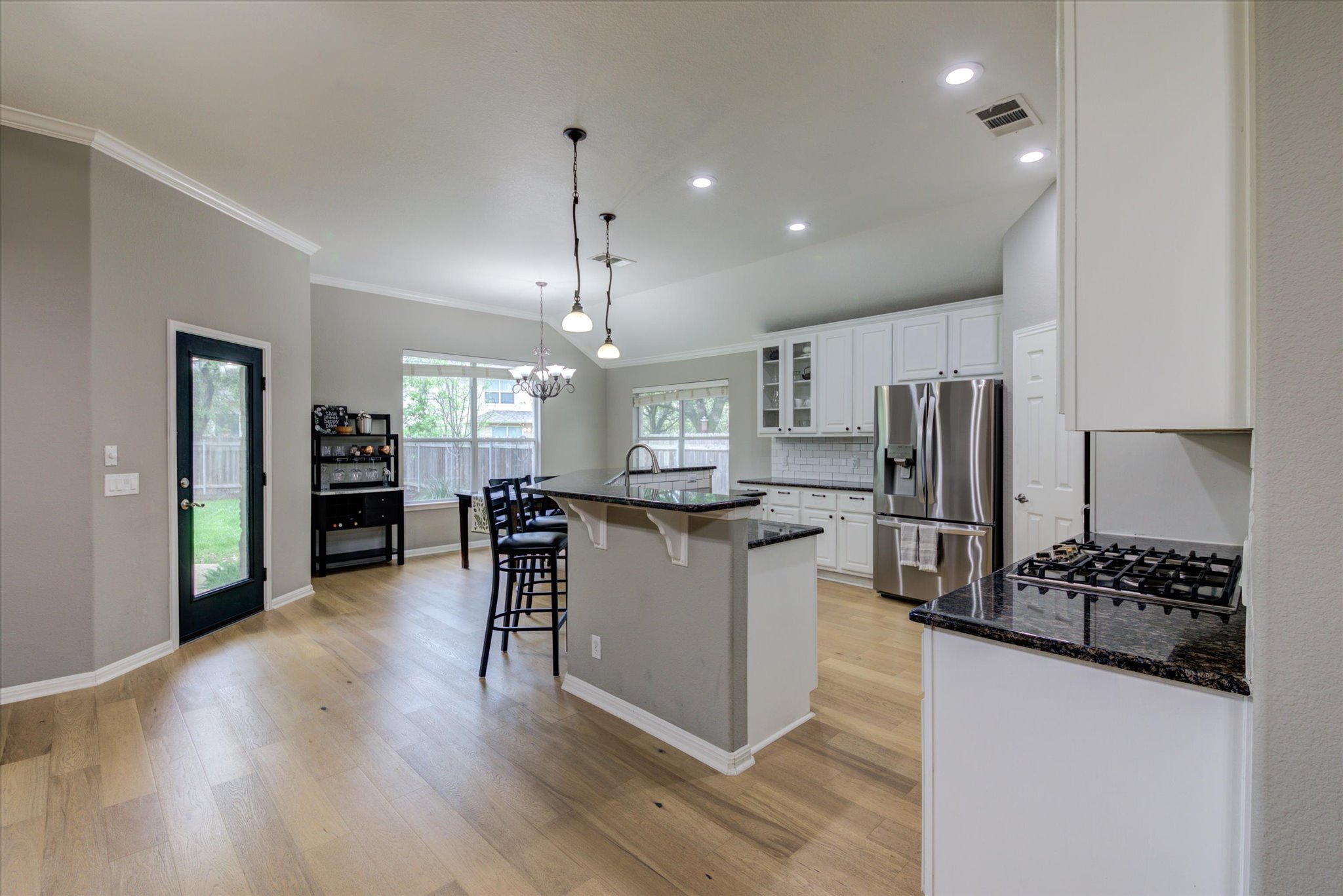 5412 Batak Lane Austin, TX 78749 - Photo 10 of 40 a kitchen with stainless steel appliances kitchen island granite countertop a refrigerator and a stove top oven