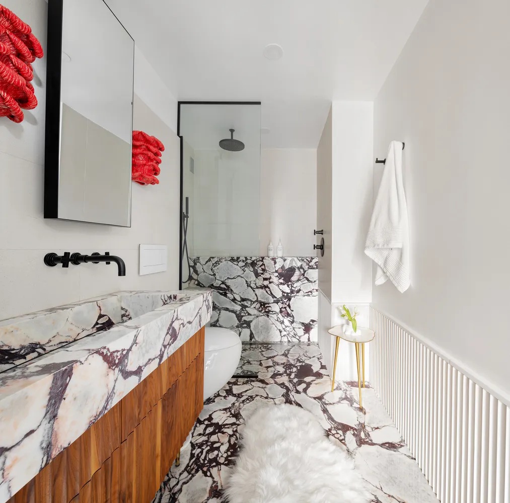 a bathroom with a tub sink and mirror