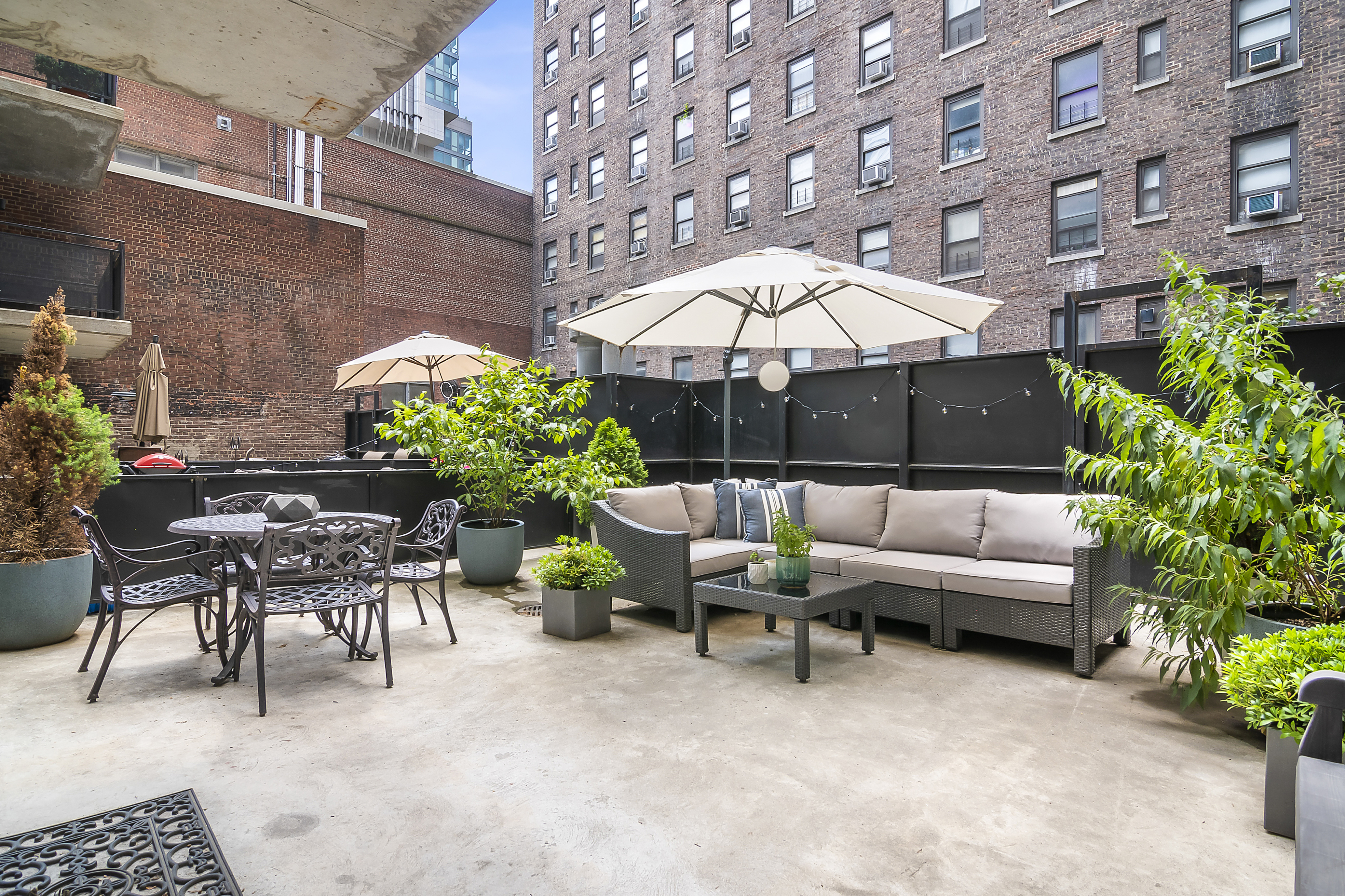 148 East 24th Street, Unit 3F Manhattan, NY 10010 - Photo 2 of 9 a view of a patio with a table and chairs under an umbrella