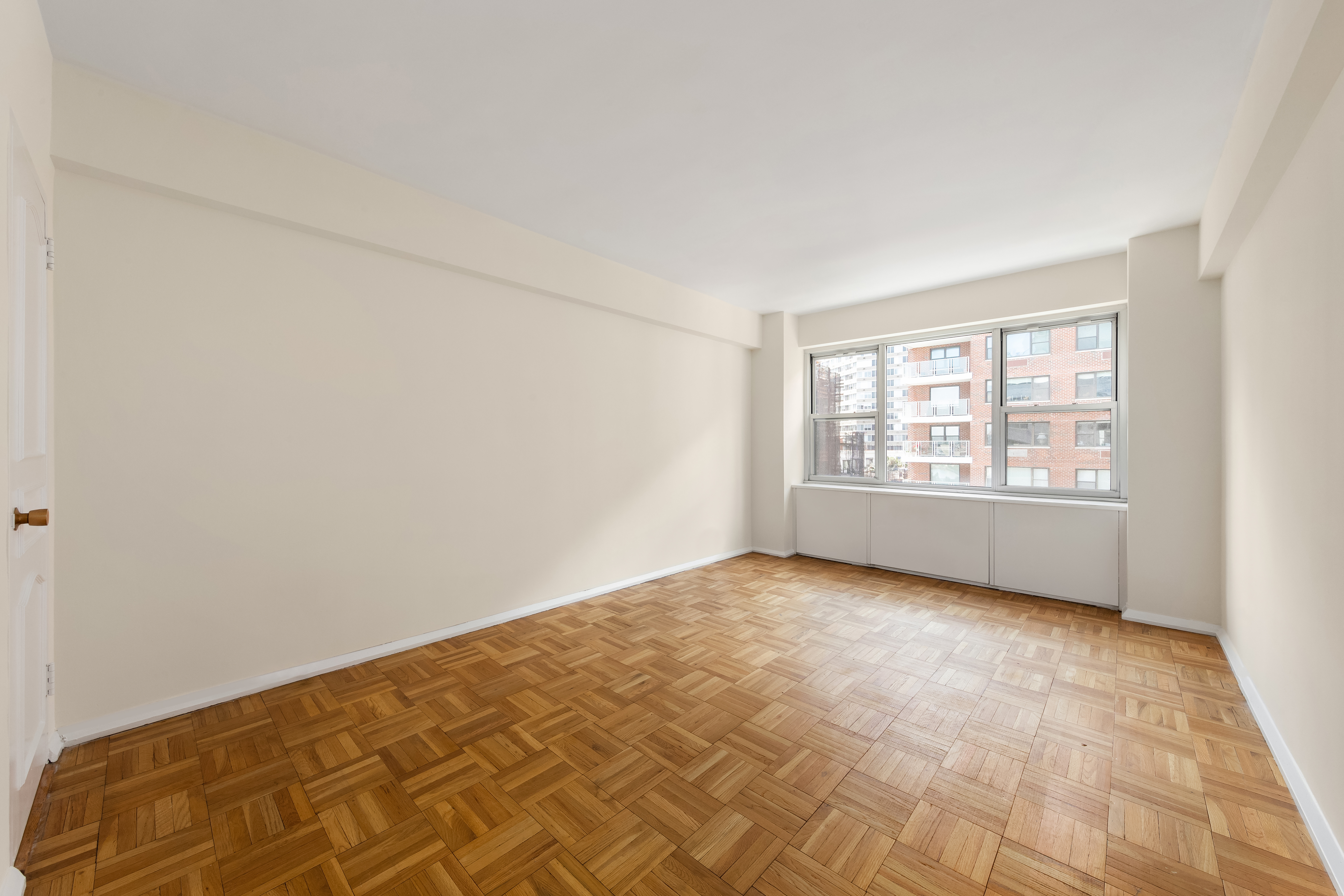 45 Sutton Place South, Unit 14N Manhattan, NY 10022 - Photo 9 of 19 an empty room with windows