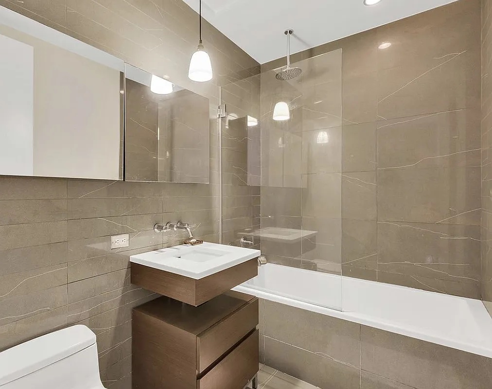 80 Metropolitan Avenue, Unit 2L Brooklyn, NY 11249 - Photo 3 of 5 a bathroom with a sink and a mirror