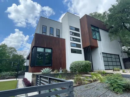 a view of house with backyard outdoor seating and hardwood