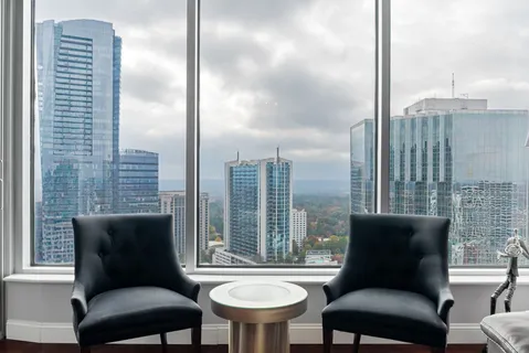 a bedroom with a bed and a large window
