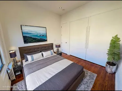 a kitchen with a refrigerator and a stove top oven