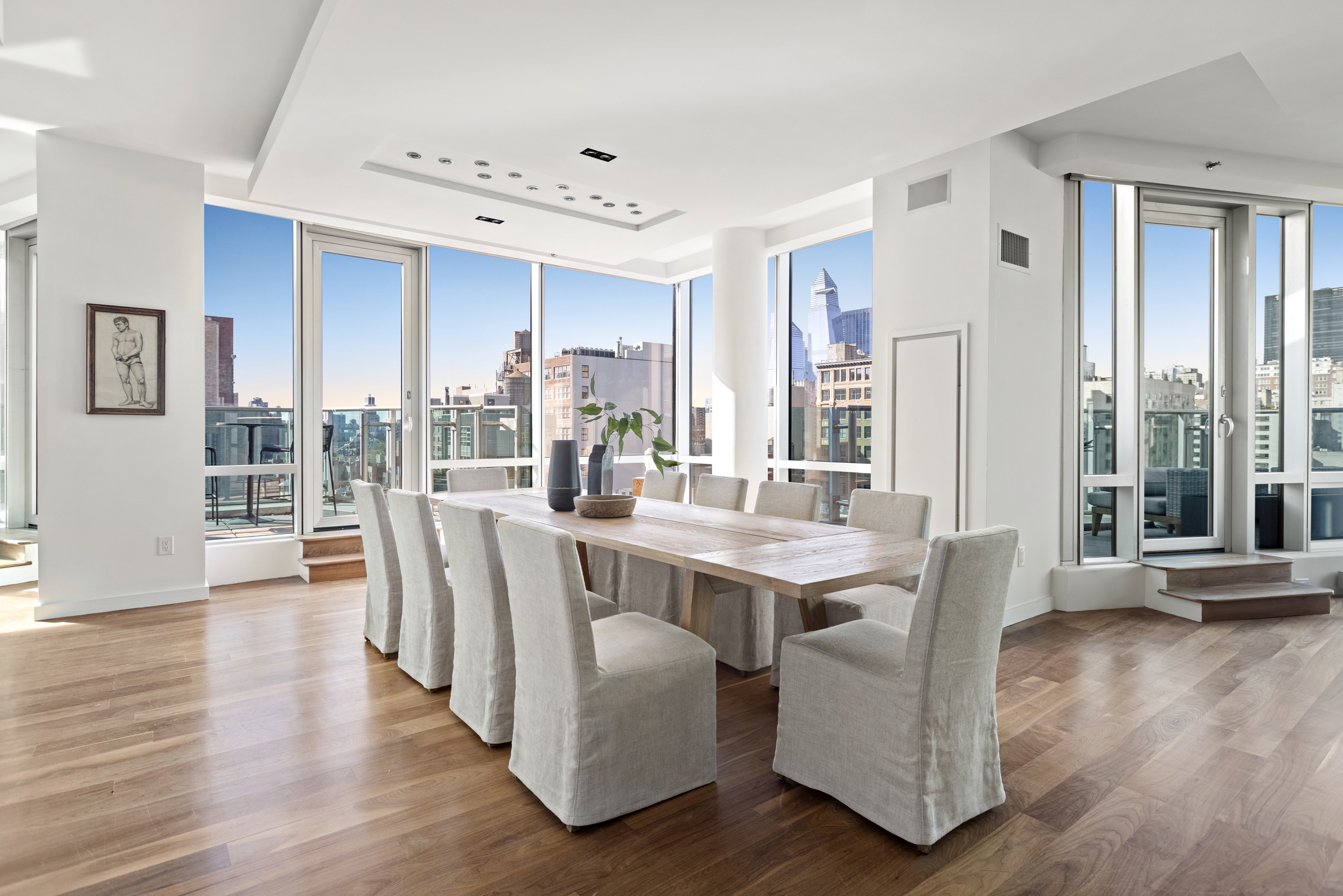 166 West 18th Street, Unit PH11 Manhattan, NY 10011 - Photo 4 of 16 a view of a dining room with furniture and wooden floor