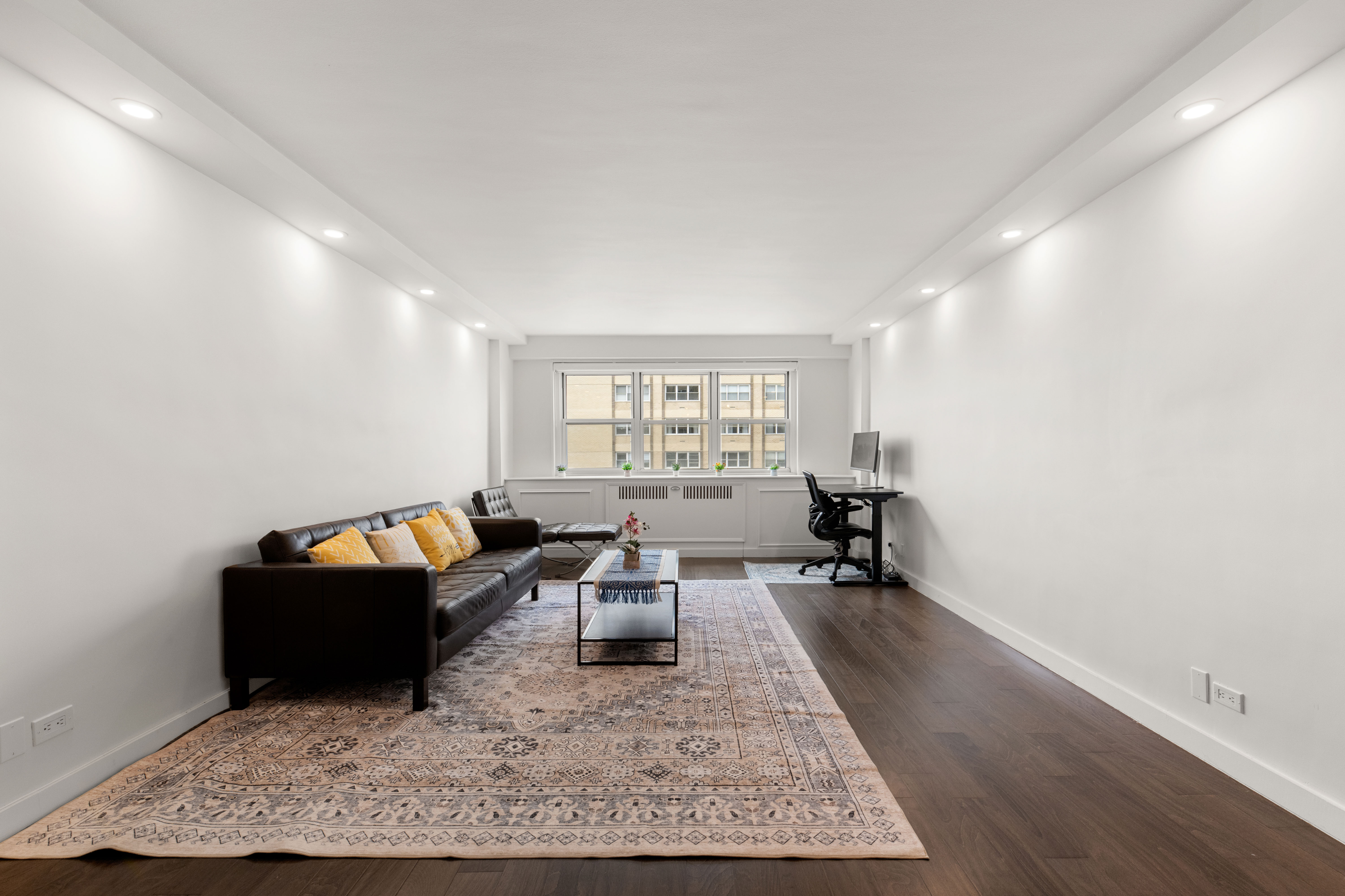66-36 Yellowstone Boulevard, Unit 24A Queens, NY 11375 - Photo 2 of 20 a living room with furniture and wooden floor