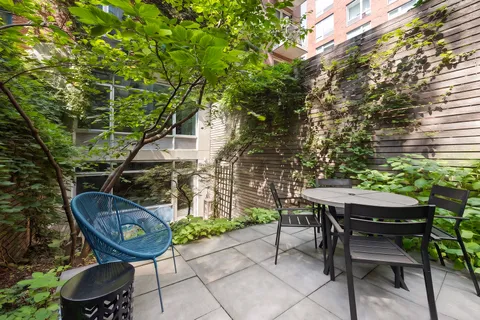 a backyard of a house with table and chairs
