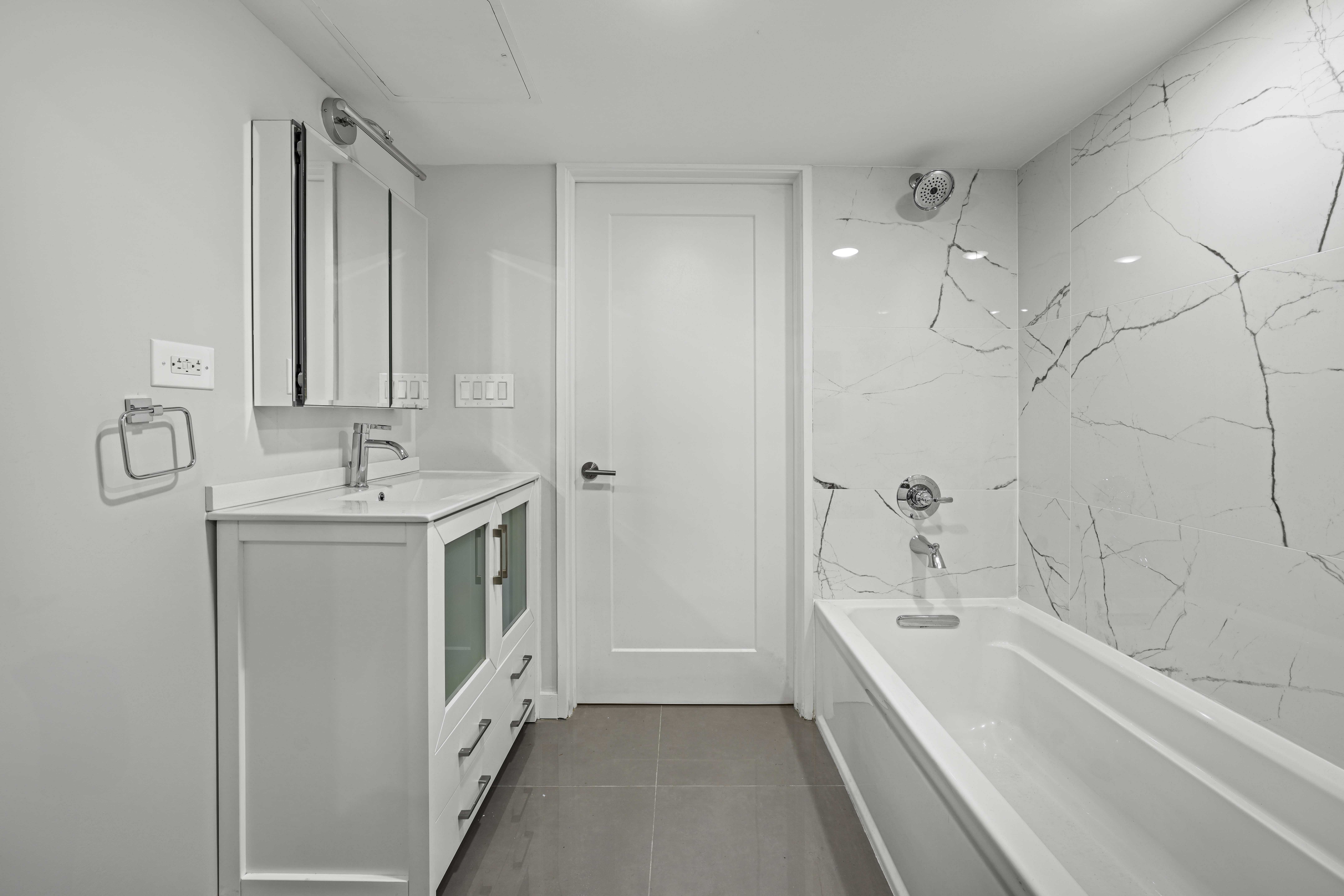 950 St Nicholas Avenue, Unit 1 Manhattan, NY 10032 - Photo 13 of 16 a bathroom with a bathtub a sink a vanity and a shower
