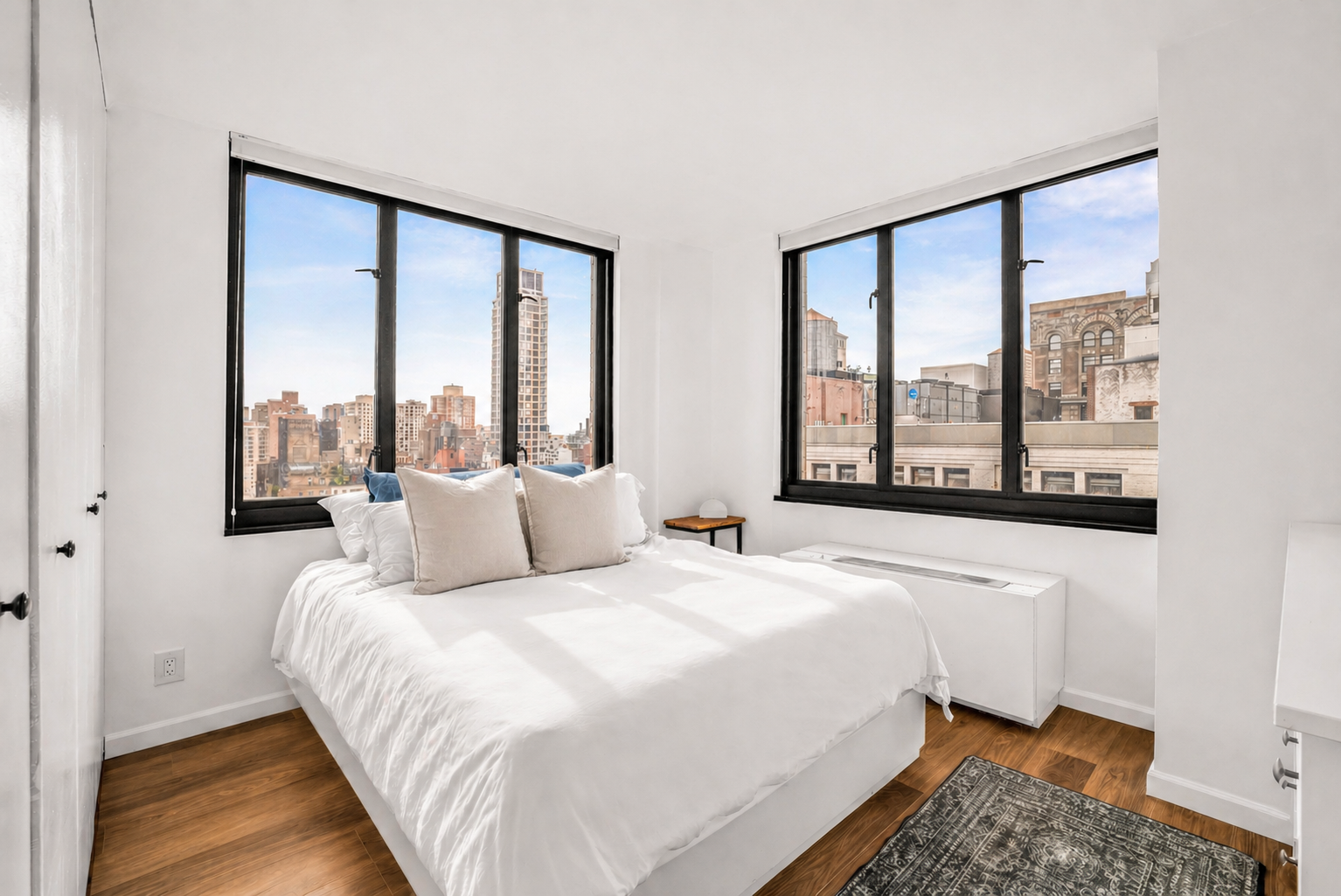 407 Park Avenue South, Unit 18B Manhattan, NY 10016 - Photo 3 of 8 a bedroom with a large bed and a large window
