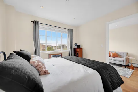 a bedroom with a large bed and a window