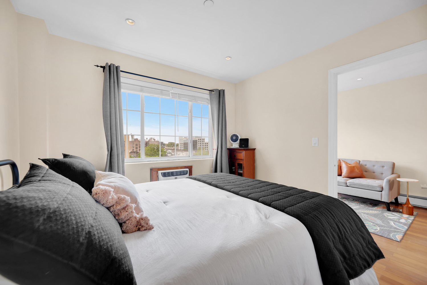 43-33 42nd Street, Unit 6B Queens, NY 11104 - Photo 6 of 8 a bedroom with a large bed and a window