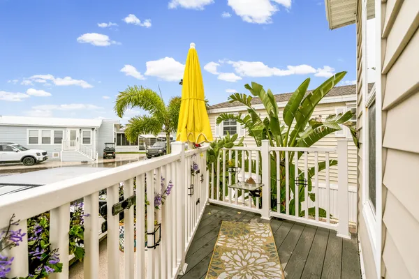 a living room with furniture kitchen view and a large window