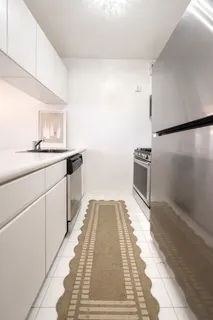 a kitchen with granite countertop a sink stove and cabinets