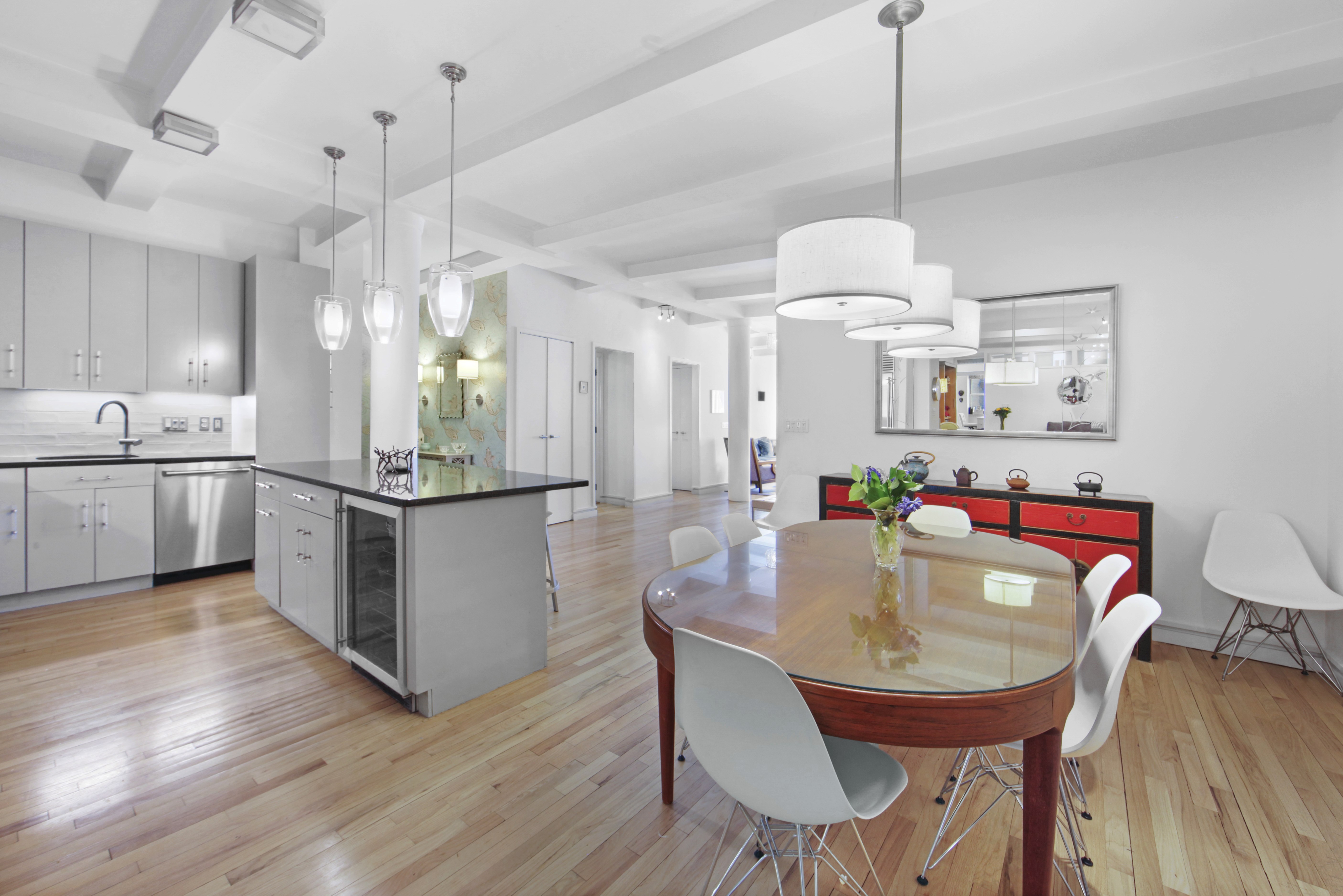 18 East 12th Street, Unit 7BC Manhattan, NY 10003 - Photo 9 of 26 a view of a dining room and livingroom with furniture wooden floor a chandelier