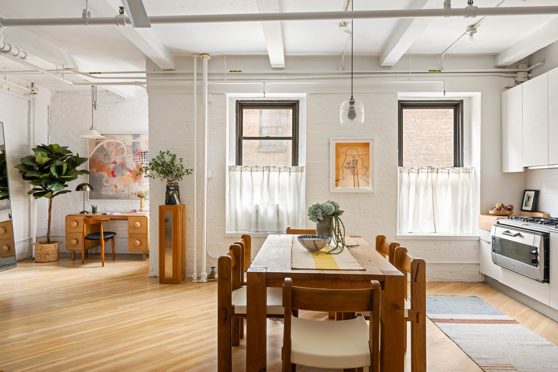 130 West 17th Street, Unit 5S Manhattan, NY 10011 - Photo 3 of 17 a view of a dining room with furniture window and wooden floor