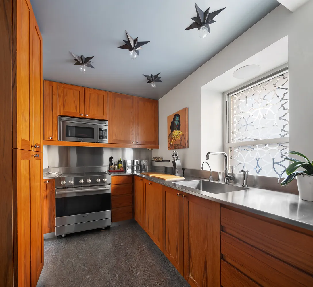 a kitchen with stainless steel appliances a stove sink and microwave