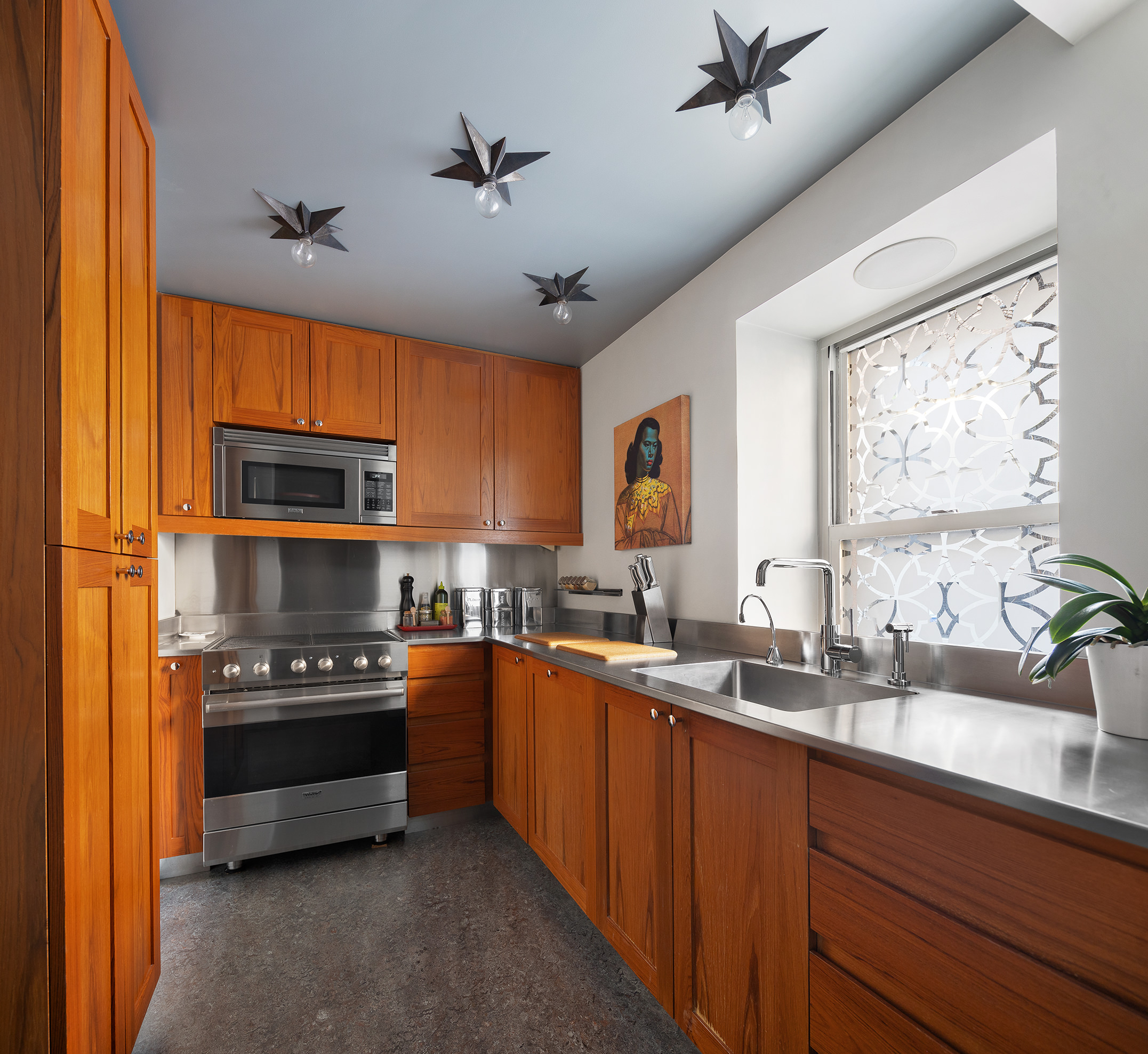 23 Park Avenue, Unit 1A Manhattan, NY 10016 - Photo 9 of 18 a kitchen with stainless steel appliances a stove sink and microwave