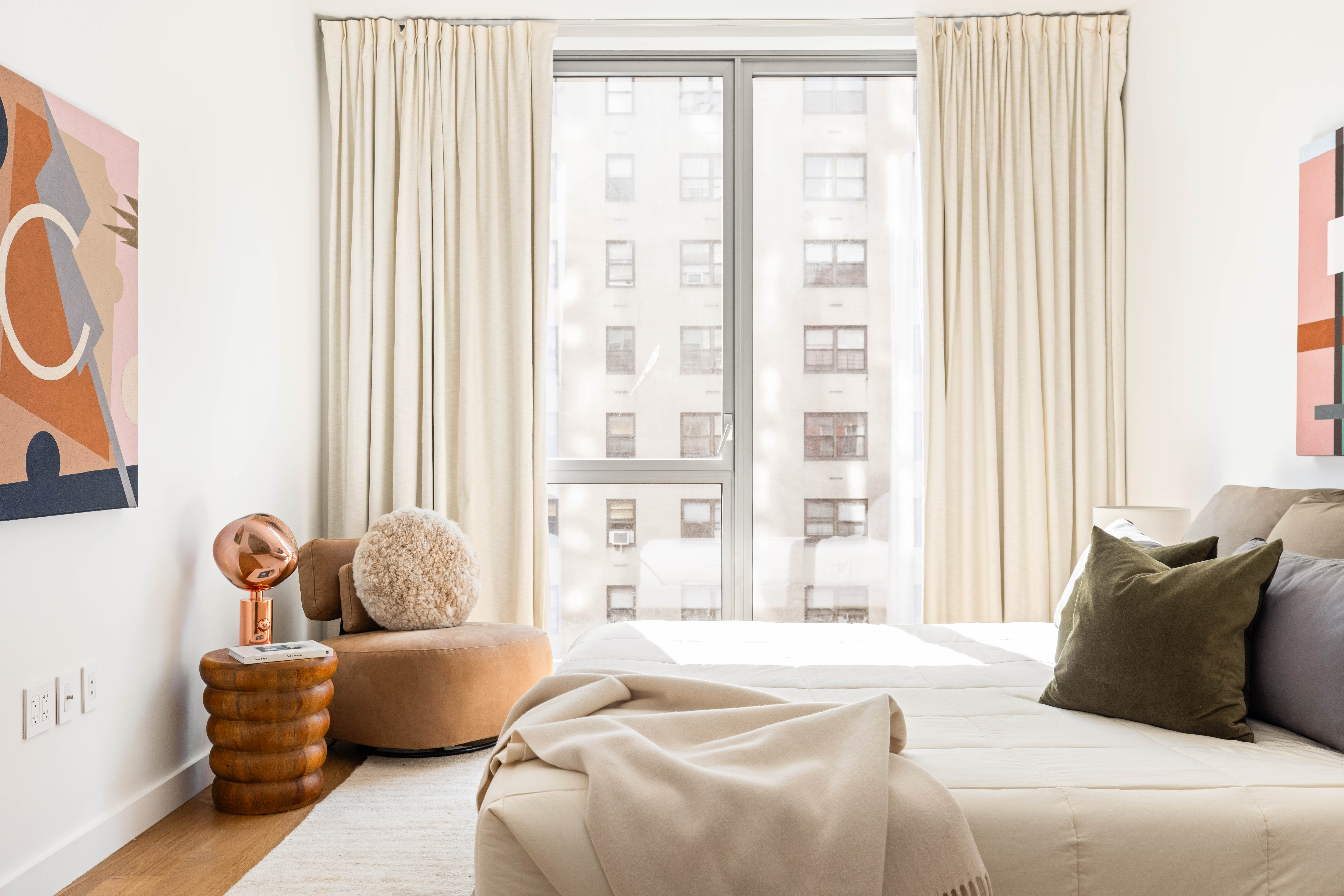 360 East 89th Street, Unit 5D Manhattan, NY 10128 - Photo 8 of 13 a bedroom with a bed and couch next to a window