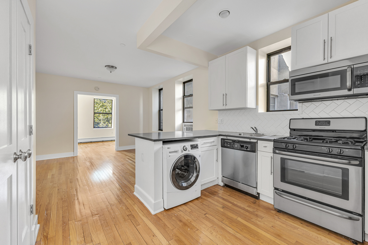 305 West 150th Street, Unit 606 Manhattan, NY 10039 - Photo 1 of 6 a kitchen with a stove a sink and a microwave