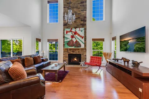 a living room with furniture fireplace and flat screen tv