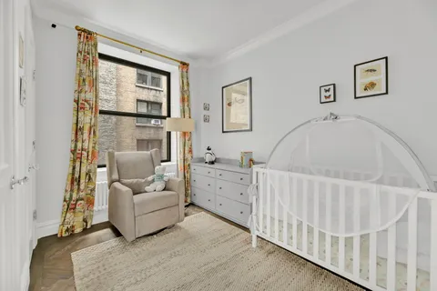 a view of a bedroom with furniture window and wooden floor