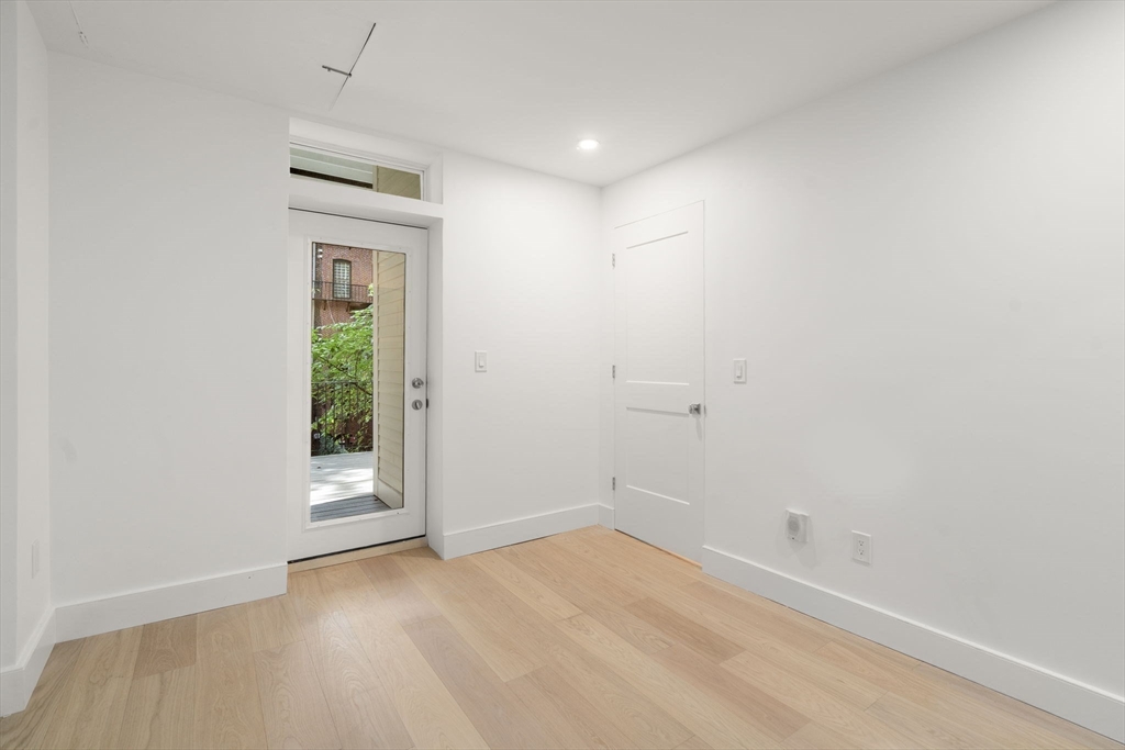 34 Worcester Square, Unit 2 Boston, MA 02118 - Photo 14 of 18 an empty room with an entryway and a window