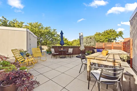 a view of a patio with table and chairs and potted plants