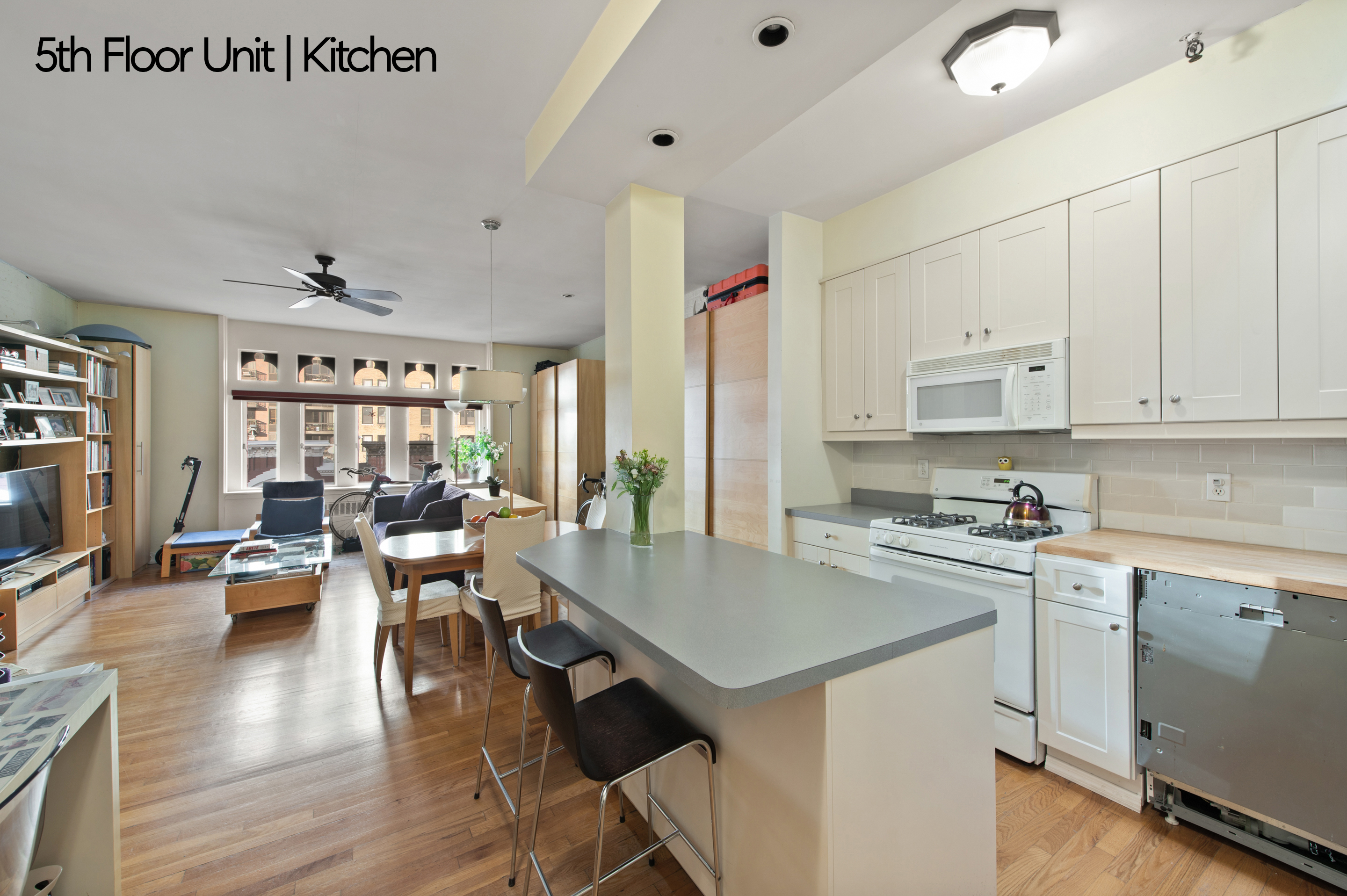 126 West 78th Street Manhattan, NY 10024 - Photo 25 of 39 a kitchen with a table chairs stove and cabinets