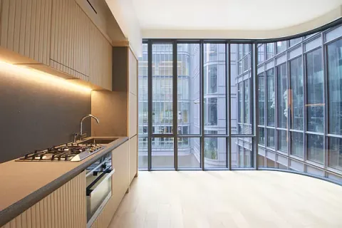 a kitchen with granite countertop a stove and a wooden cabinets