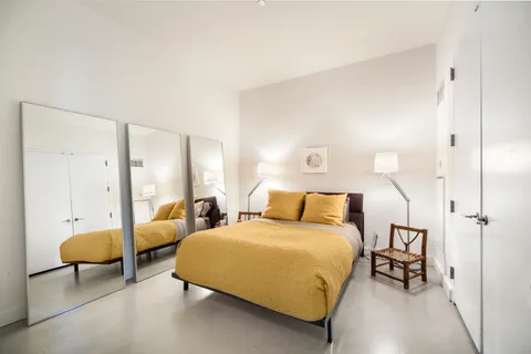 a bedroom with bed and a chandelier