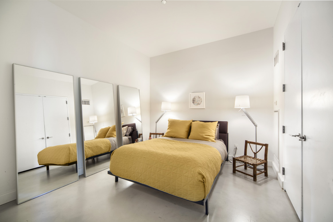 420 West 25th Street, Unit 3B Manhattan, NY 10001 - Photo 5 of 15 a bedroom with bed and a chandelier